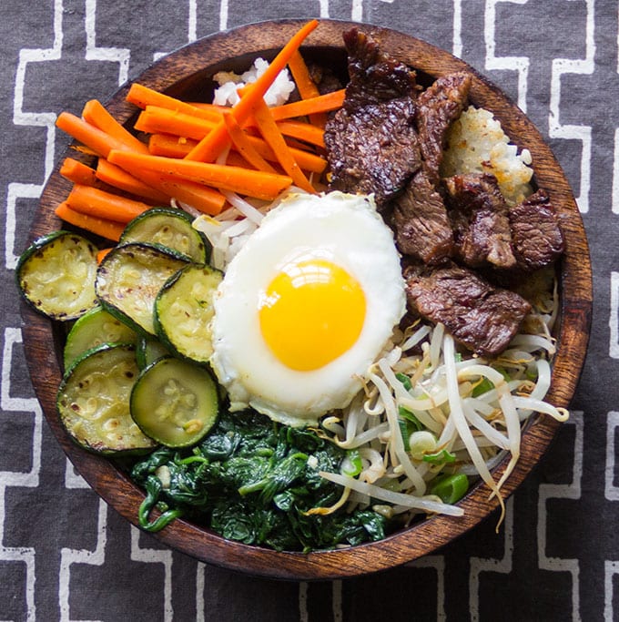 Bibimbap • Korean rice bowl with marinated beef, vegetables and a fried egg • Panning The Globe