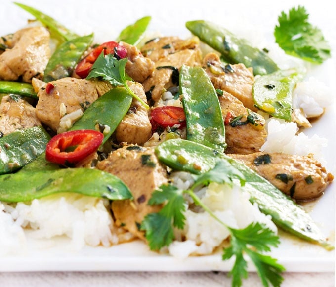 Fresh ginger, coconut milk and basil are the base of this fragrant Thai green curry chicken recipe. Fluffy white rice is all you need to complete the meal. Perfect for weeknights when you want something quick and delicious.