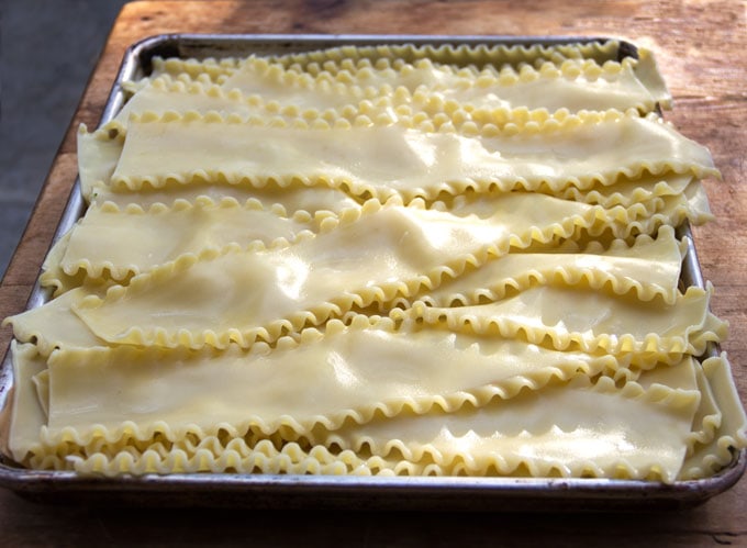 cooked lasagna noodles set out to cool on a tray