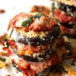 A stack of breaded eggplant, thick tomato sauce and melted cheese.