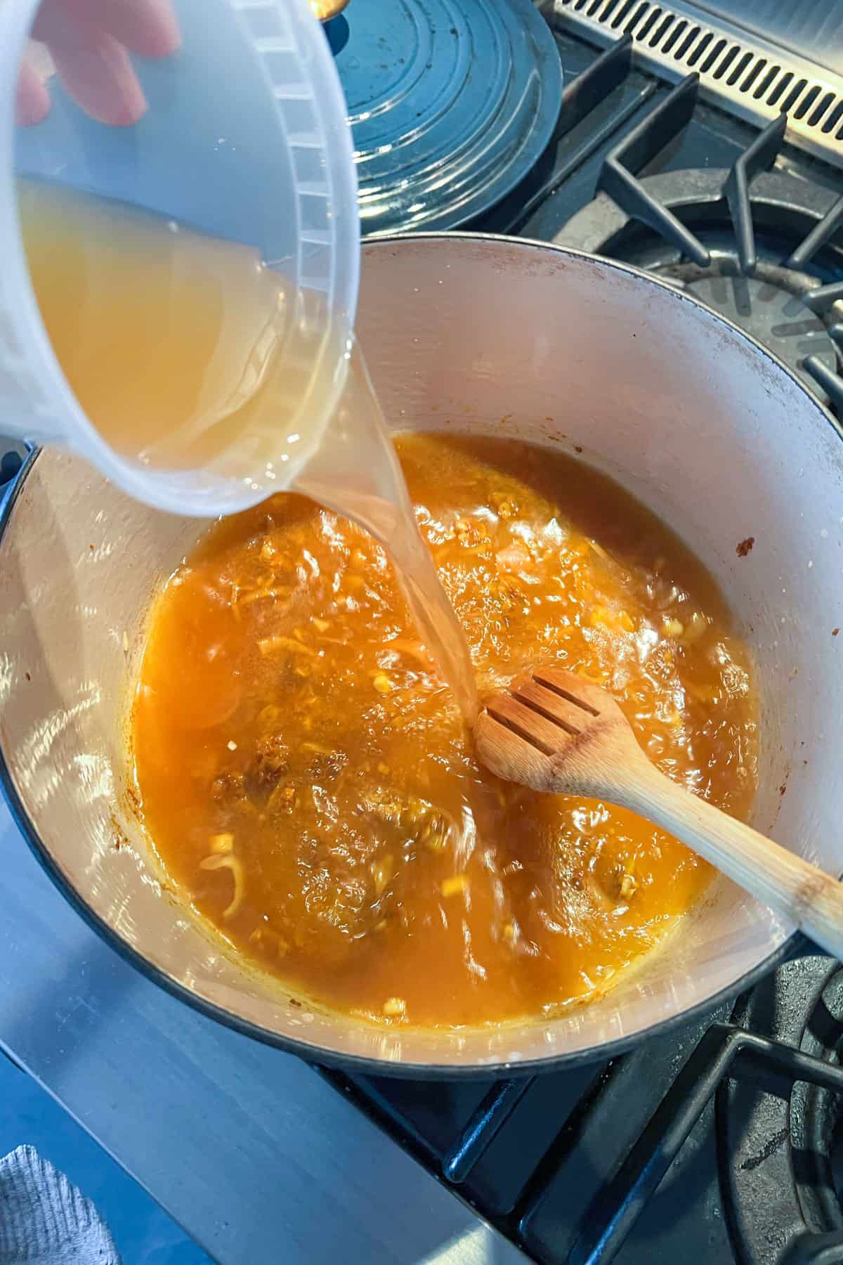 Adding chicken stock to coconut curry chicken soup