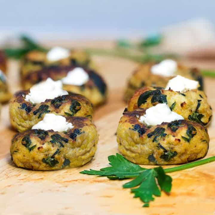 mini potato knishes topped with sour cream.