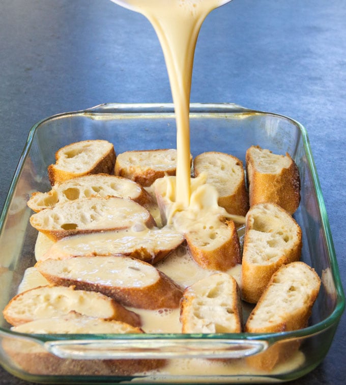 french bread in a casserole with custard poured over it