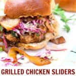 bbq chicken slider on a bun with coleslaw and caramelized onions falling out of it