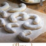 Pinterest pin: almond crescent cookies on a piece of parchment