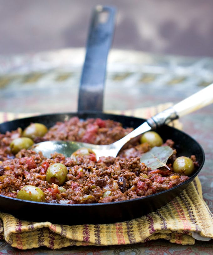 Cuban Picadillo is a sweet and sour ground beef stew in a flavorful tomato sauce with vinegar, onions, garlic, olives and smoked paprika. The recipe is quick and easy, 35 minutes start to finish. Serve Picadillo over mashed potatoes, rice or quinoa to soak up all the delicious sauce.
