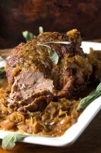 Pork Roast with Sauerkraut Apples and Onions is a delicious festive dish that takes only 5 ingredients and 20 minutes of prep. It's easy enough for Sunday dinner and special enough for New Year's Eve.