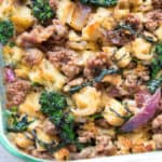 sausage stuffing with bits of broccoli rabe and red onion in a glass casserole