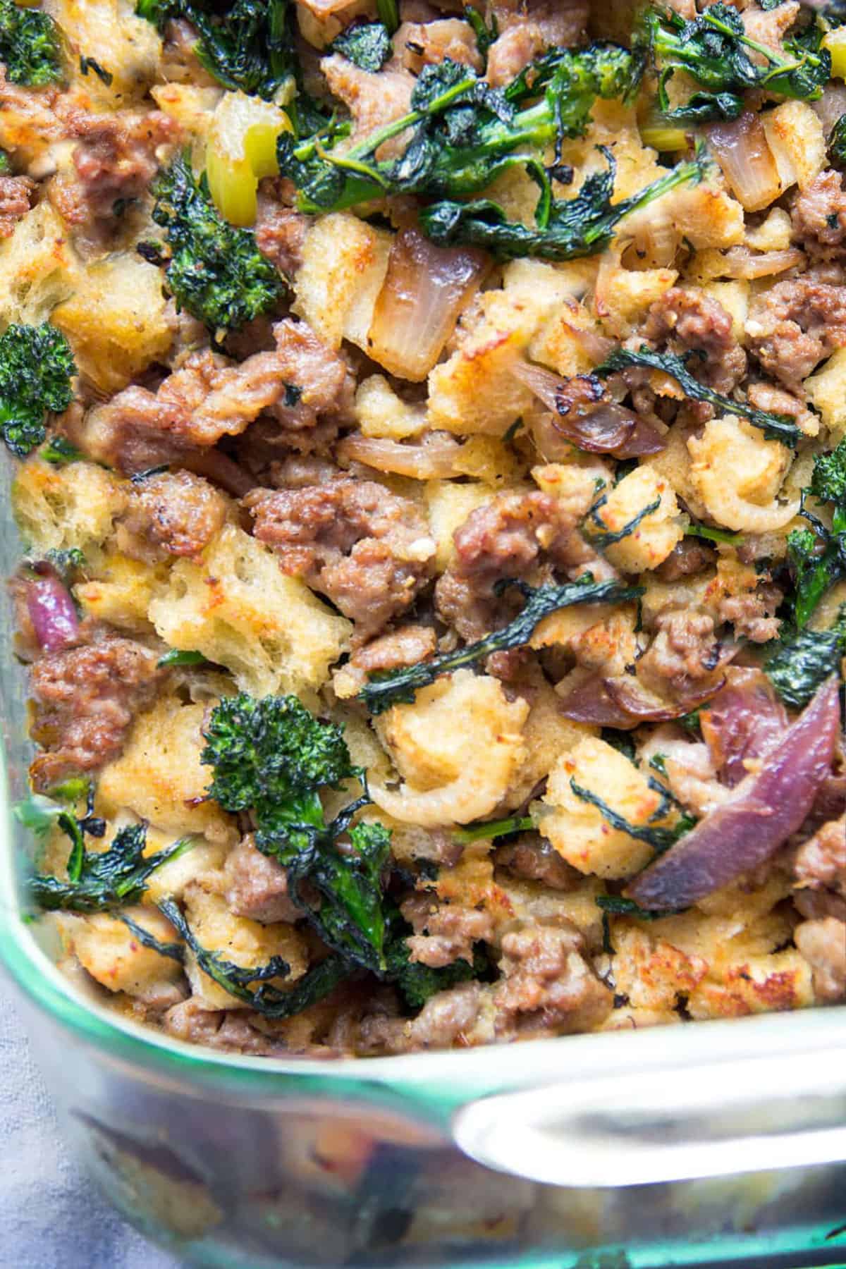 close up of sausage and bread stuffing with broccoli rabe, onions and celery.