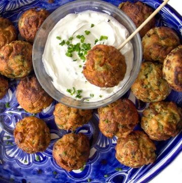 These Savory Potato Aebleskivers are potato pancakes like you've never had them before. The batter is made from tender red lentils, shredded potatoes, herbs and chilies. The pancakes are cooked in a special pan that forms them into golden brown spheres that are crisp on the outside, fluffy and tender inside. Serve these scrumptious bites as a party appetizer or a game day snack. As a bonus, these potato aebleskivers are gluten-free, dairy-free, and egg-free.