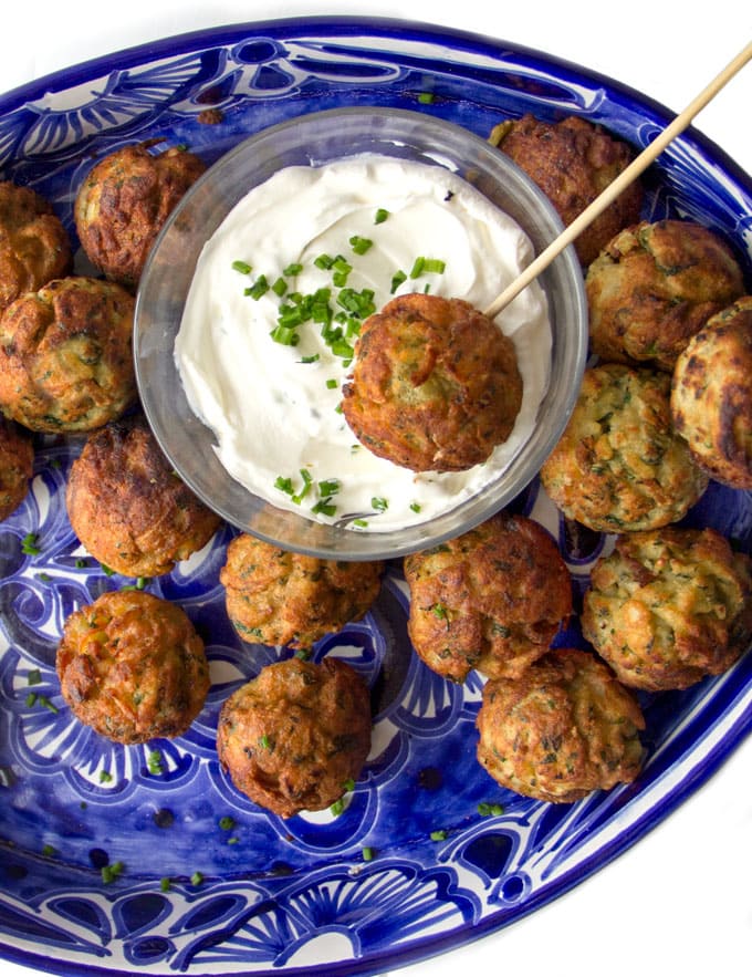 These Savory Potato Aebleskivers are potato pancakes like you've never had them before. The batter is made from tender red lentils, shredded potatoes, herbs and chilies. The pancakes are cooked in a special pan that forms them into golden brown spheres that are crisp on the outside, fluffy and tender inside. Serve these scrumptious bites as a party appetizer or a game day snack. As a bonus, these potato aebleskivers are gluten-free, dairy-free, and egg-free.