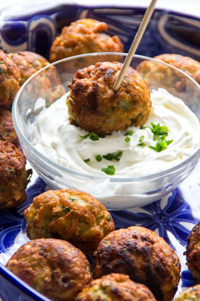 These Savory Potato Aebleskivers are potato pancakes like you've never had them before. The batter is made from tender red lentils, shredded potatoes, herbs and chilies. The pancakes are cooked in a special pan that forms them into golden brown spheres that are crisp on the outside, fluffy and tender inside. Serve these scrumptious bites as a party appetizer or a game day snack. As a bonus, these potato aebleskivers are gluten-free, dairy-free, and egg-free.