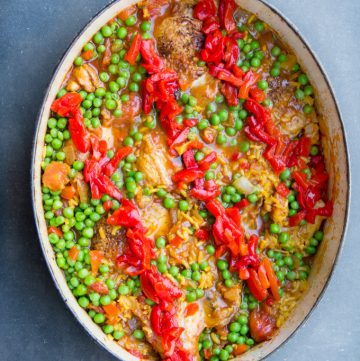 Arroz Con Pollo is Spain's beloved chicken and rice casserole. It's the best chicken and rice casserole recipe and easy to make at home. A one pot wonder with tender chicken and yellow rice in a scrumptious sauce of tomatoes, aromatic vegetables, and spices.