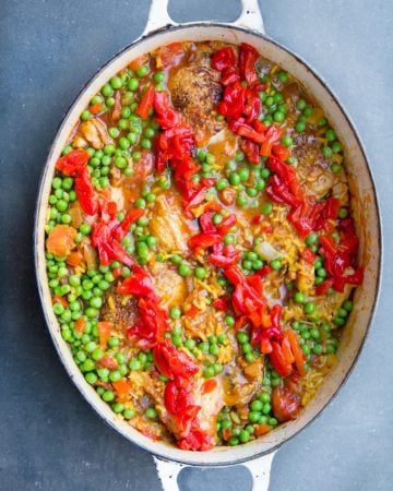 Arroz Con Pollo is Spain's beloved chicken and rice casserole. It's the best chicken and rice casserole recipe and easy to make at home. A one pot wonder with tender chicken and yellow rice in a scrumptious sauce of tomatoes, aromatic vegetables, and spices.