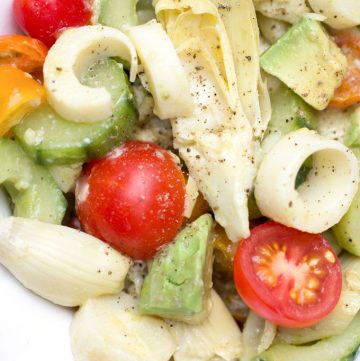 close up of hearts of palm salad with cucumbers, artichoke hearts and cherry tomatoes