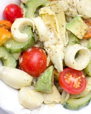 close up of hearts of palm salad with cucumbers, artichoke hearts and cherry tomatoes