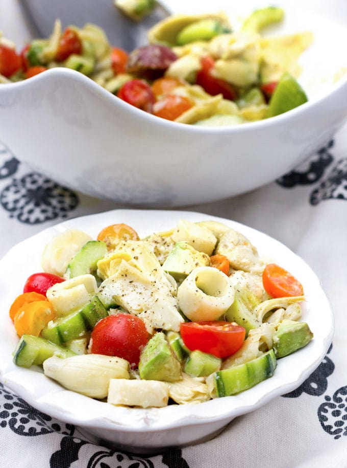 chunky salad with artichoke hearts, hearts of palm, cherry tomatoes, cucumbers and avocado