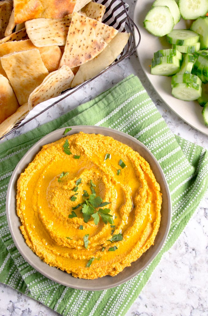 Chipotle Carrot Hummus: naturally sweet carrots and smoky chipotle chile powder makes this nutritious hummus sweet, spicy and delicious! It takes 15 minutes to make and it's the perfect healthy dip for spring and summer.