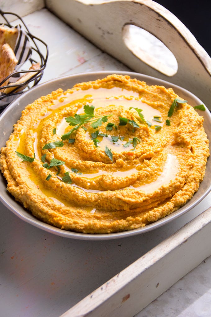 Chipotle Carrot Hummus: naturally sweet carrots and smoky chipotle chile powder makes this nutritious hummus sweet, spicy and delicious! It takes 15 minutes to make and it's the perfect healthy dip for spring and summer.