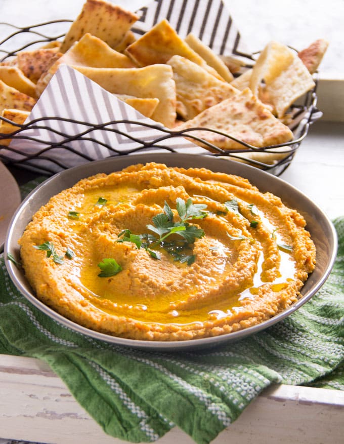 Chipotle Carrot Hummus: naturally sweet carrots and smoky chipotle chile powder makes this nutritious hummus sweet, spicy and delicious! It takes 15 minutes to make and it's the perfect healthy dip for spring and summer.