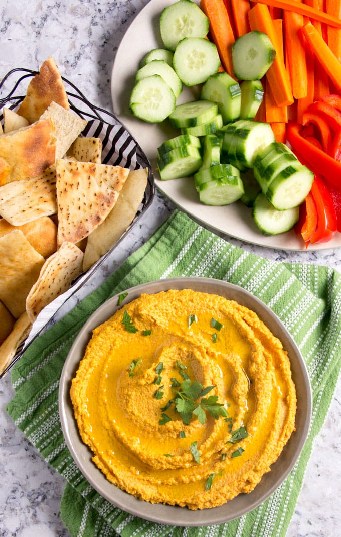 Chipotle Carrot Hummus: naturally sweet carrots and smoky chipotle chile powder makes this nutritious hummus sweet, spicy and delicious! It takes 15 minutes to make and it's the perfect healthy dip for spring and summer.