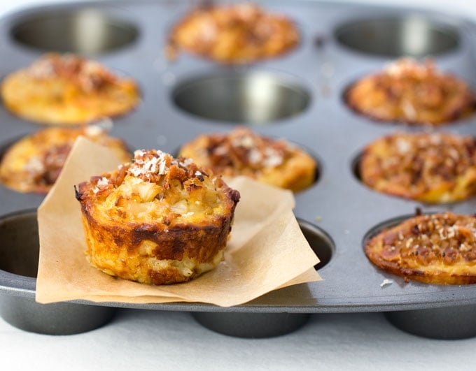 These savory cauliflower tarts are amazing little flavor bombs: potato-gruyere crusts filled with onions, garlic, cauliflower, eggs, cheese, and spices, topped with bacon and parmesan. A perfect recipe for a special brunch, with an easy vegetarian adaptation.