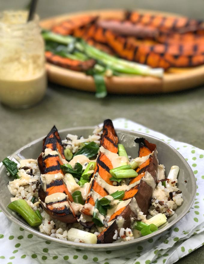 Grilled Sweet Potatoes: Here's a fabulous technique for cooking sweet potato wedges to perfection without frying them. Crisp and caramelized outside, sweet and tender inside, firm enough to hold up to a salad or to grab in hand and dip into a tasty dressing or aioli. These are some seriously great grilled sweet potatoes!