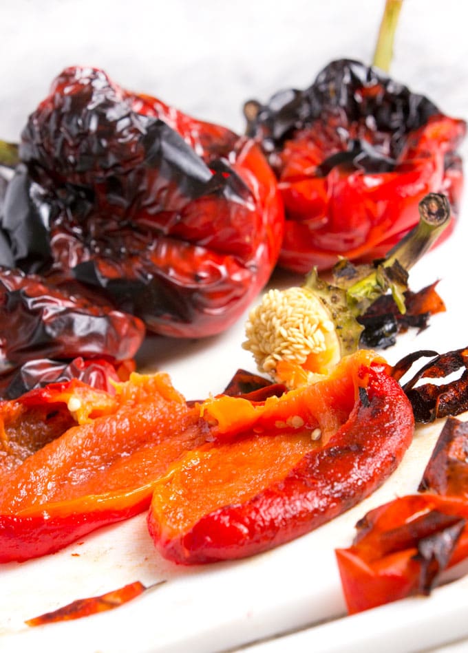Roasted red peppers bear little resemblance to raw red bell peppers. The roasting process transforms them from firm and crunchy and to velvety soft and it brings out their natural sweetness. Whether you roast them in the oven or on the grill, the process is simple and totally satisfying. Homemade roasted peppers are exceptionally good - tender and fruity - way better than the kind you get in a jar.