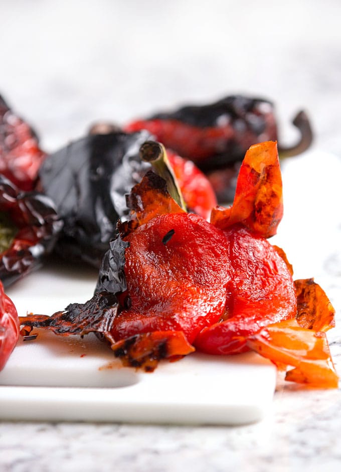 Roasted red peppers bear little resemblance to raw red bell peppers. The roasting process transforms them from firm and crunchy and to velvety soft and it brings out their natural sweetness. Whether you roast them in the oven or on the grill, the process is simple and totally satisfying. Homemade roasted peppers are exceptionally good - tender and fruity - way better than the kind you get in a jar.