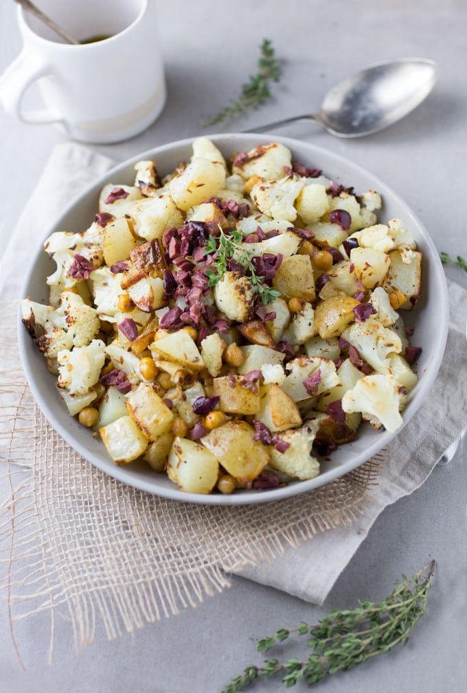 Roasted Cauliflower, Potatoes and Chickpeas tossed in a bright lemon olive vinaigrette. Serve as a side dish or vegetarian main. [gluten-free recipe]