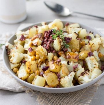 Roasted Cauliflower, Potatoes and Chickpeas tossed in a bright lemon olive vinaigrette. Serve as a side dish or vegetarian main. [gluten-free recipe]