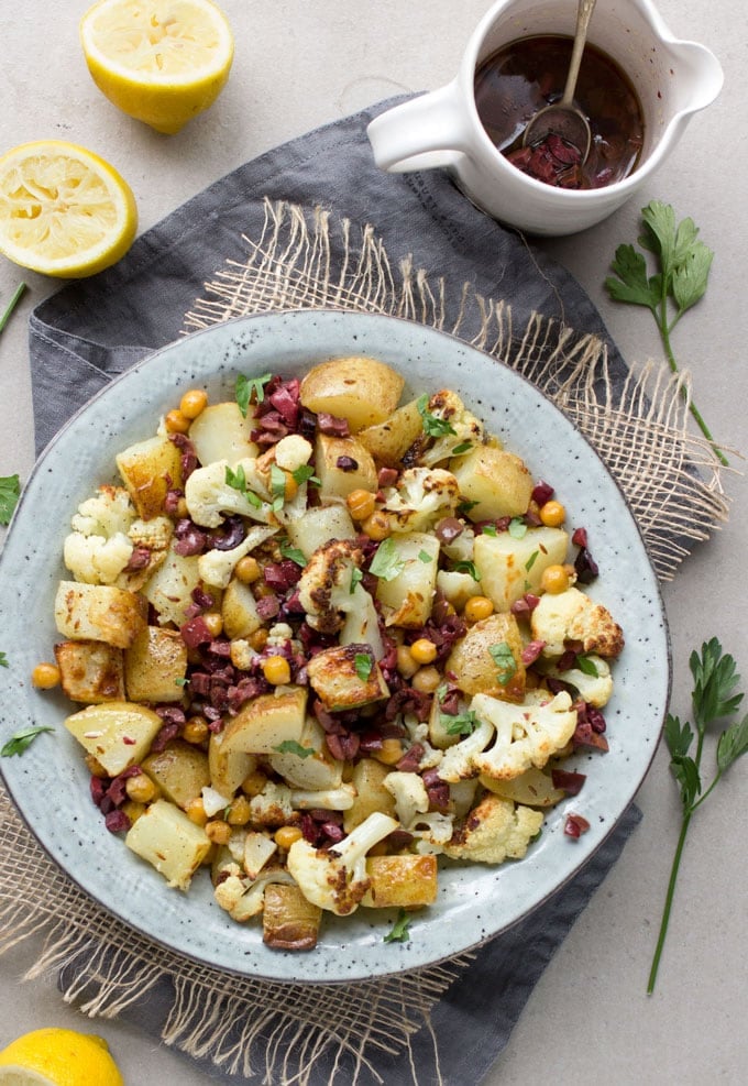 Roasted Cauliflower, Potatoes and Chickpeas tossed in a bright lemon olive vinaigrette. Serve as a side dish or vegetarian main. [gluten-free recipe]