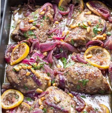 Here's an amazing roast chicken recipe from chef Yotam Ottolenghi. Chicken thighs are spiced with za'atar and sumac, tossed with onions, lemons and garlic, and roasted. This is a great dinner party recipe because it's a beautiful dish, you can do all the prep ahead, the chicken is tender and juicy, and the flavors are fantastically delicious!