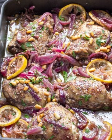 Here's an amazing roast chicken recipe from chef Yotam Ottolenghi. Chicken thighs are spiced with za'atar and sumac, tossed with onions, lemons and garlic, and roasted. This is a great dinner party recipe because it's a beautiful dish, you can do all the prep ahead, the chicken is tender and juicy, and the flavors are fantastically delicious!