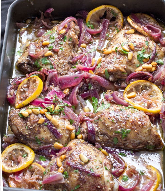 Here's an amazing roast chicken recipe from chef Yotam Ottolenghi. Chicken thighs are spiced with za'atar and sumac, tossed with onions, lemons and garlic, and roasted. This is a great dinner party recipe because it's a beautiful dish, you can do all the prep ahead, the chicken is tender and juicy, and the flavors are fantastically delicious!