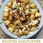 Pinterest Pin: a bowl of roasted cauliflower, potatoes and chickpeas with kalamata olive vinaigrette
