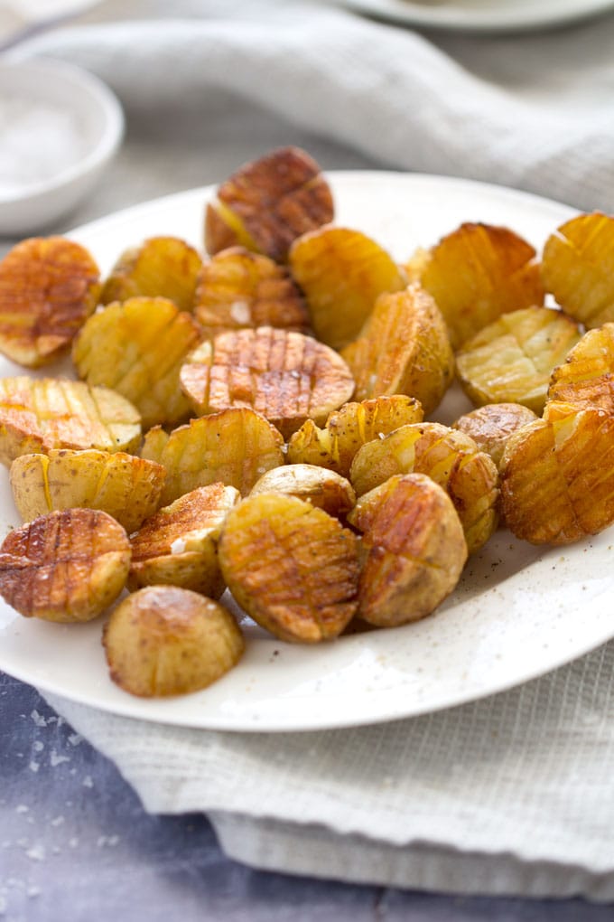 Mini inside-out hasselback potatoes are crisscross-cut mini potatoes that roast up extra golden brown and crispy on the outside and creamy inside. Whether you season these with salt and pepper or fancy them up with truffle salt and grated parmesan, they're delicious and fun and everyone will love them!