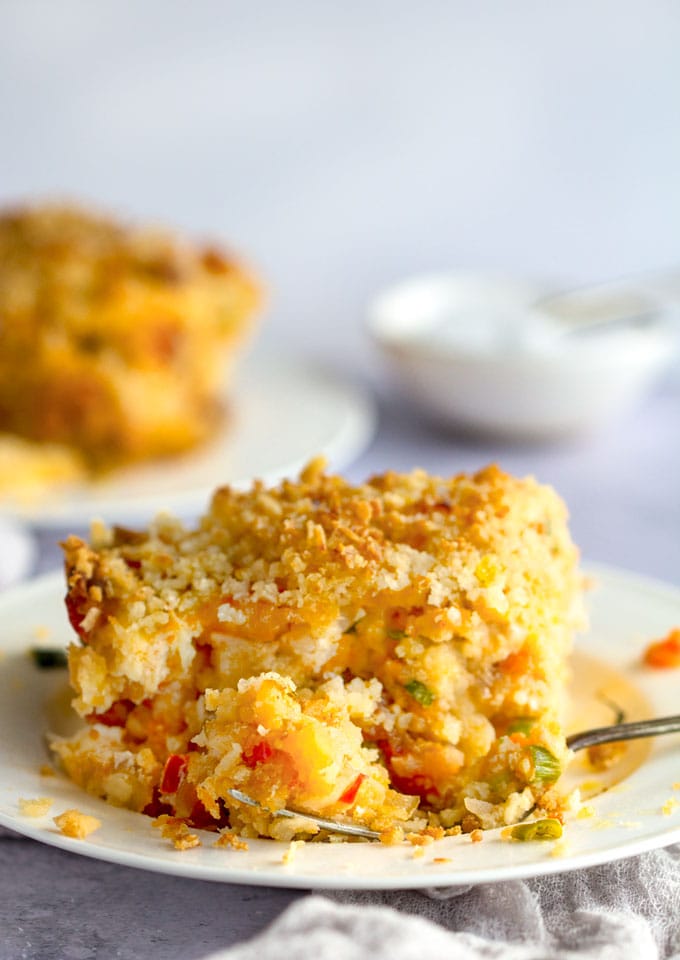 This cheesy shredded potato casserole recipe is an update on classic Funeral Potatoes, amped up on flavor with spicy chorizo, smoked paprika and sweet bell peppers, and made lighter and healthier with no canned soup and yogurt instead of sour cream l Panning The Globe