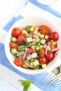 Mediterranean chickpea salad with cucumbers, feta, cherry tomatoes, herbs and lemony dressing. Yum! l www.panningtheglobe.com