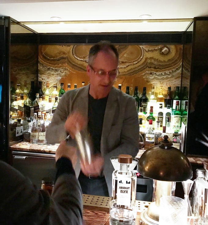 Eddie shaking up his basil vodka gimlet cocktail at Club George in London, behind the bar