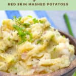 Pinterest pin with red skin mashed potatoes in a brown wooden bowl topped with chopped scallions