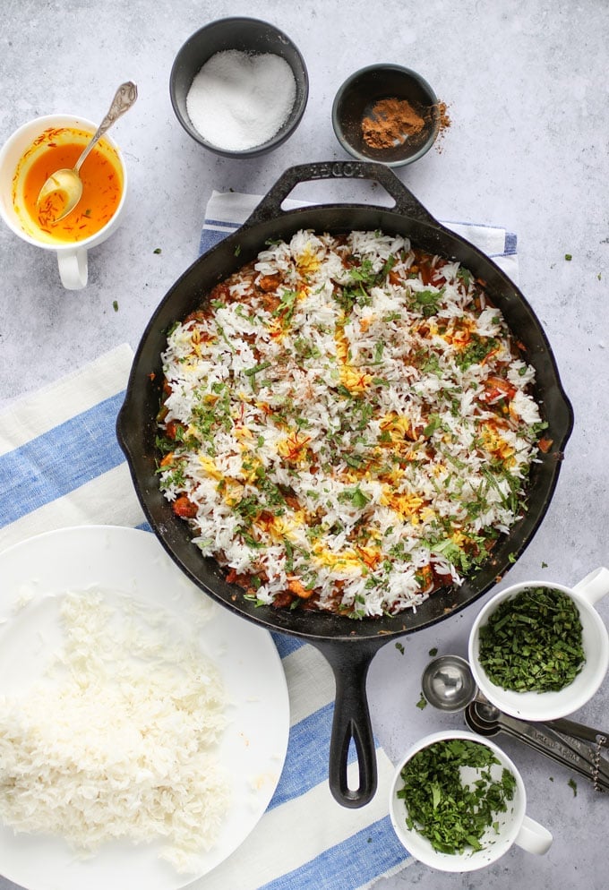 how to assemble chicken biryani in a skillet with rice, herbs, spices and saffron milk