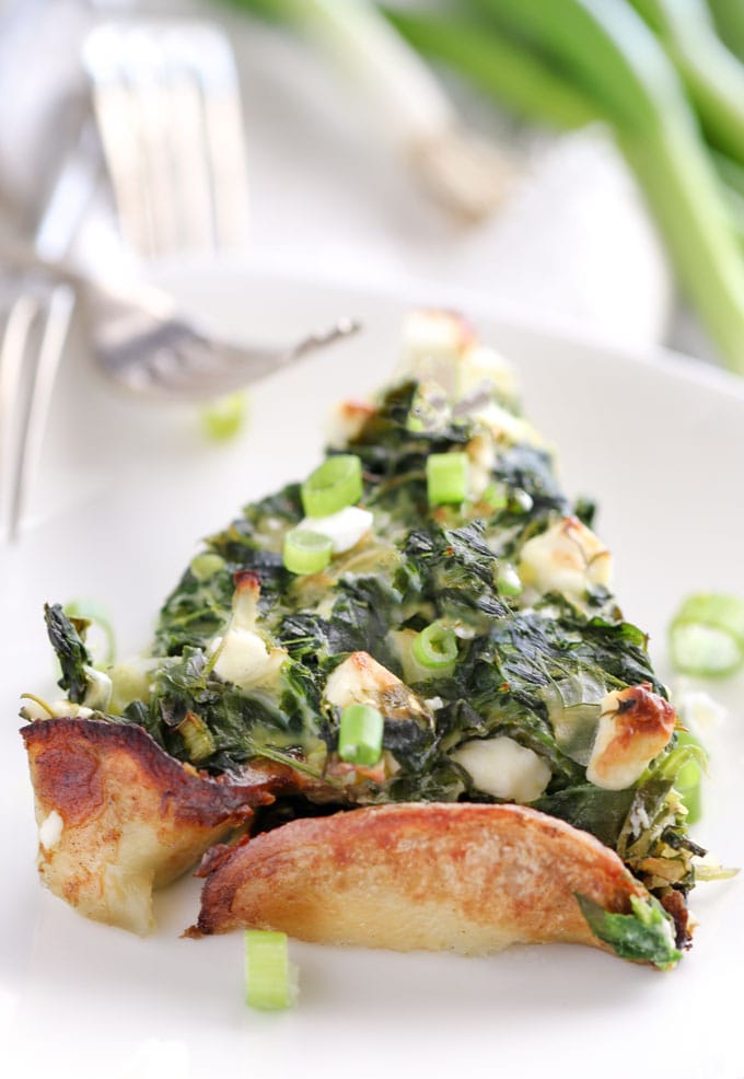 a slice of greek spinach pie in potato crust