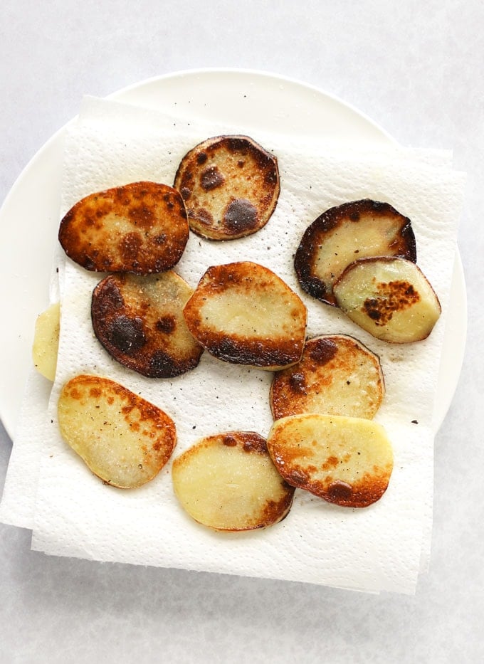 sliced sautéd potatoes draining on paper towels, for making a potato crust.