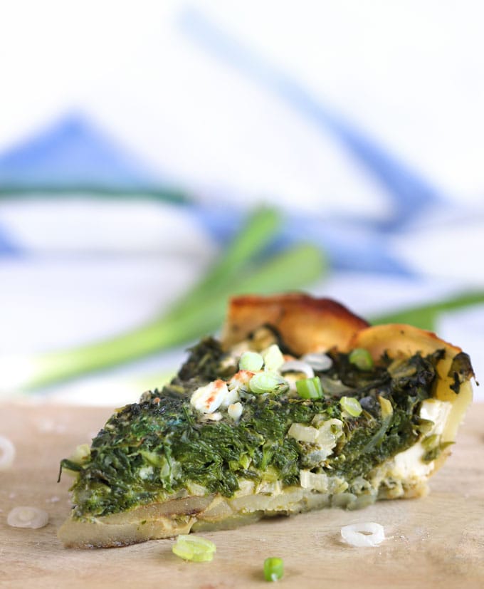 a slice of greek spinach pie in potato crust