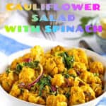 pinterest pin: white bowl on a blue and white striped dish towel, filled with bright yellow turmeric roasted cauliflower salad