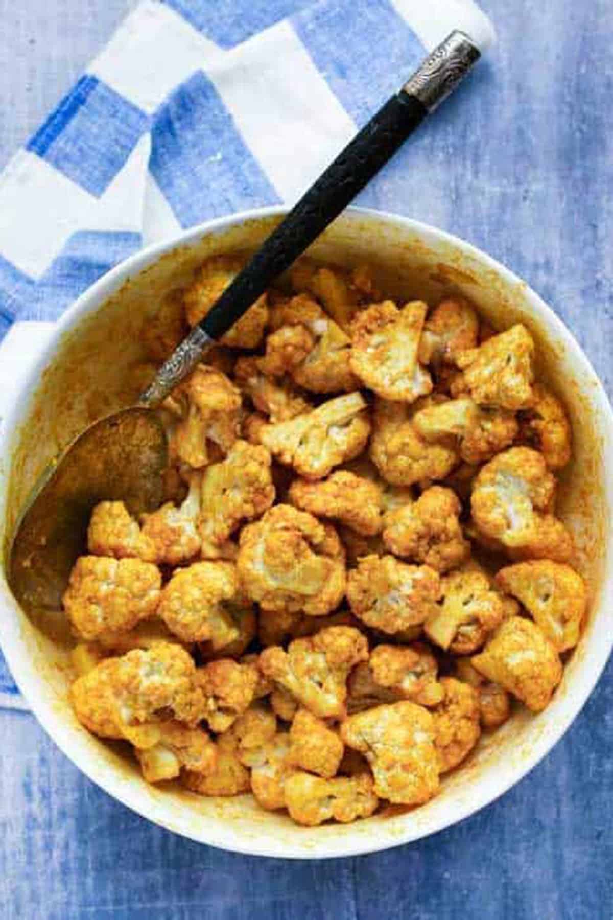 turmeric spiced raw cauliflower florets in a bowl