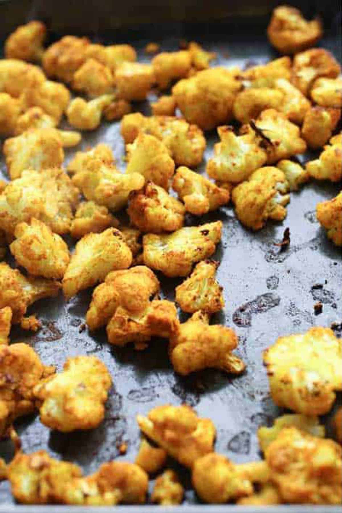 turmeric roasted cauliflower on a rimmed baking sheet