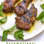 Pinterest Pin: 4 grilled lamb chops on a white plate with mint sprigs