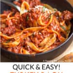 Pinterest Pin: a black bowl filled with tagliatelle pasta with turkey ragu, some of it being twirled around a fork